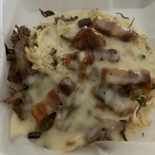 Arepas Con Todo - Traditional corn cakes topped with a delicious variety of meats and savory toppings.