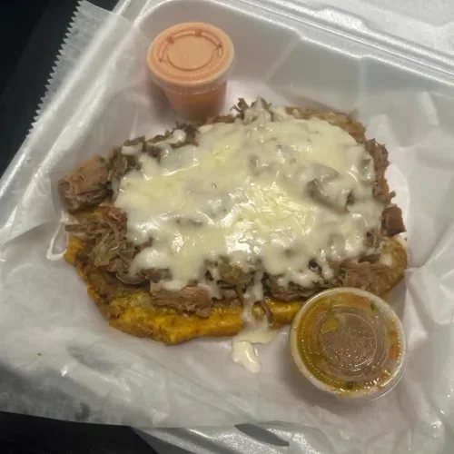 Fried Plantains with Steak - Crispy fried plantains topped with savory grilled steak.